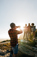 Wall Mural - young hikers taking pictures outdoors