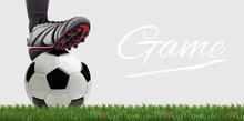 Soccer Ball With Football Player Feet On Green Grass