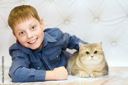 Boy Lying Down And Smiling Kitten Of The British Shorthair Blue