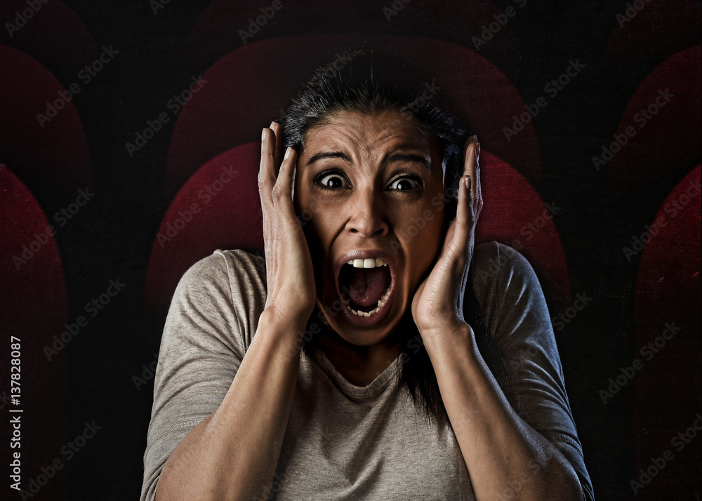 woman desperate and scared terrorized at cinema hall watching horror ...
