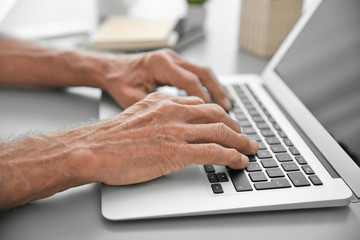 Canvas Print - Male hands typing on laptop, closeup