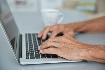 Canvas Print - Male hands typing on laptop, closeup