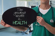 © dream@do - Male doctor holding health inspiration motivation quote on blackboard.