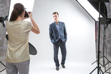 Wall Mural - Photographer working with model in studio