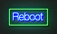 Reboot Neon Sign On Brick Wall Background.