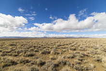 Wide Open Empty Desert Landscape In Nevada During Winter With Blue Skies And Clouds.  Mountains In The Distance.