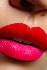 Wall Mural - Cosmetics, makeup. Bright lipstick on lips. Closeup of beautiful female mouth with red and pink lip makeup. Part of face