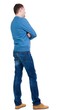 © ghoststone - Back view of handsome man in blue pullover looking up.   Standing young guy in jeans. Rear view people collection.  backside view of person.  Isolated over white background.