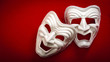 Comedy and Tragedy theatrical mask isolated on a red background and copy space
