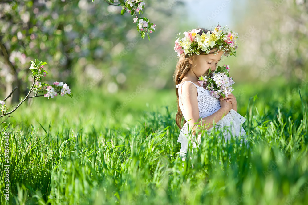 Little girl in garden with flowers Stock Photo | Adobe Stock