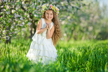 Little girl in garden with flowers 