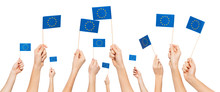 Hands Holding And Raising European Union Flags
