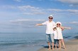 © altanaka - Father and children playing on the beach at the day time.