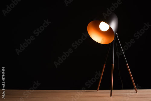 Desk lamp on empty wooden office table Poster Mural XXL