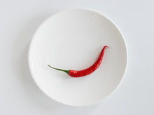 Red Chili Pepper On White Plate.