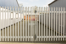 Set Of Locked Spiked Security Gates At An Industrial Or Commercial Premises