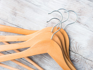 Wooden clothes hangers on bright background. What nothing to wear concept