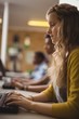 © WavebreakMediaMicro - Smiling schoolgirl studying in computer classroom