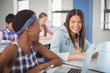 © WavebreakMediaMicro - Students interacting with each other in classroom