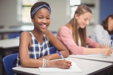 Wall Mural - Student sitting at desk in classroom