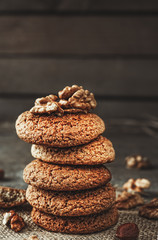 Wall Mural - Crispy cookies with cocoa and nuts, dark wood background, selective focus