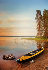 Wall Mural -  Kayak at lakeside at sunset. Karelia, Russia