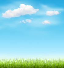 Green Grass Lawn With Clouds On Blue Sky