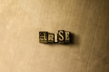 ARISE - close-up of grungy vintage typeset word on metal backdrop. Royalty free stock illustration.  Can be used for online banner ads and direct mail.