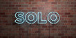 SOLO - fluorescent Neon tube Sign on brickwork - Front view - 3D rendered royalty free stock picture. Can be used for online banner ads and direct mailers..