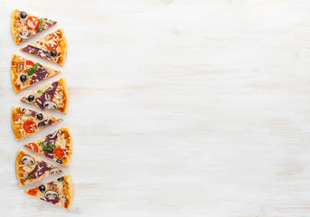 fresh pizza in a rustic Italian style with jerky olives mushrooms and three kinds of cheese on a light wooden background