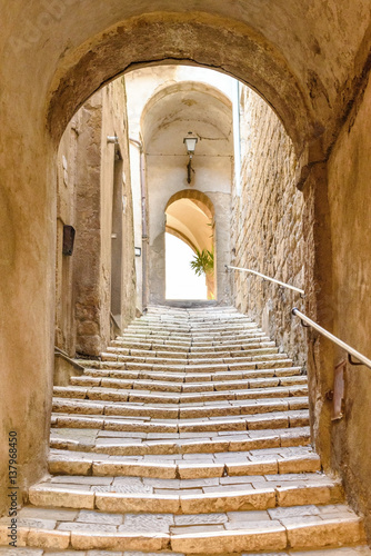 Naklejka na szybę old stone steps and arch in the medieval village, Pitigliano, tuscany, italy