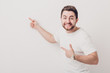 © producer - handsome smilling man with beard pointing copy space. young man