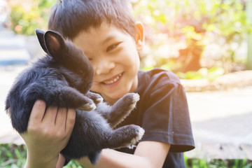 Kid playing lovely baby rabbit