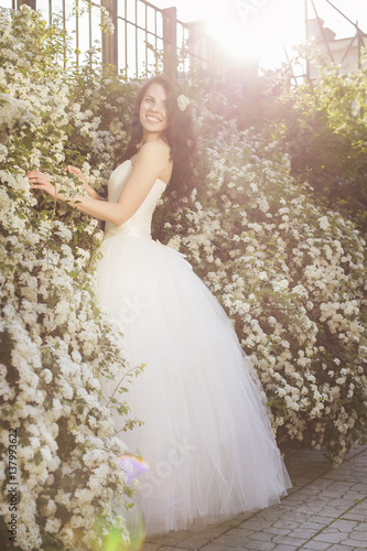 Beautiful Brunette Woman Bride In A Garden Park In White Wedding