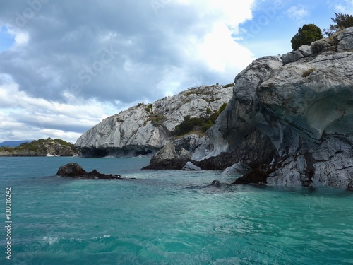 Small Marble Cliffs Above The Stunning Turquoise Waters Of A