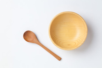 Wall Mural - Wooden bowl and spoon on white background