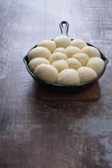 Bread proofing in a cast iron skillet. Rustic background. 