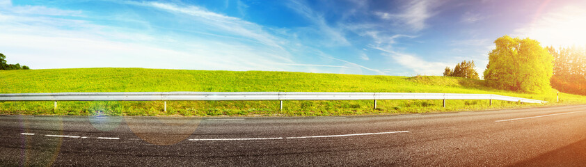 Wall Mural - asphalt road panorama in countryside on sunny spring evening