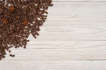  Coffee beans with star anise on old white table. Top view.