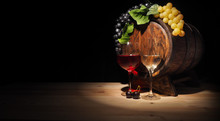 Glass Of Red , White Wine And Barrel On Wooden Table