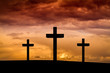 Jesus Christ cross in Easter Friday evening on red, orange sky with dramatic clouds,dark sunset. Three wood crosses on Golgota Mountain. Calvary, Easter,Crucifixion, resurrection, Good Friday concept