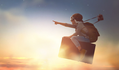 child flying on a suitcase