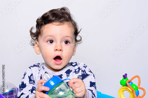 Portrait Of A Cute Toddler Drinking Water From The Bottle One