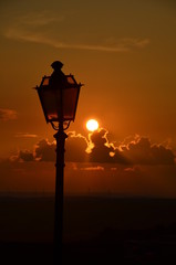 Lit Vertical Lightposts with Sunrise Background 