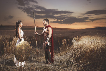 Wall Mural - Couple meeting after war in field at night time.