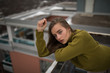 © GAM Studios - Portrait of young woman on balcony