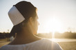 © ADDICTIVE STOCK - Young man with cap looking at sunset