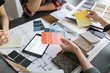 © ZeroThree - An interior designer consults with clients