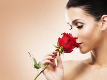 Romantic Woman Holding Red Rose On Beige Background