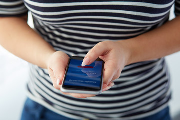 Woman using the smartphone with mobile banking screen